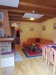 a living room with a couch and a table at Apartment Bolfenk in Pohorje