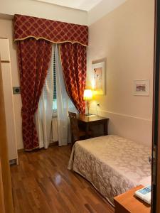 Postel nebo postele na pokoji v ubytování Hotel Arcadia