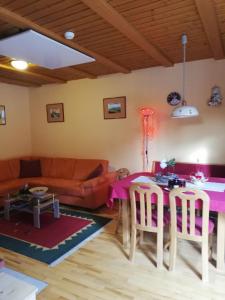 a living room with a table and a couch at Apartment Bolfenk in Pohorje