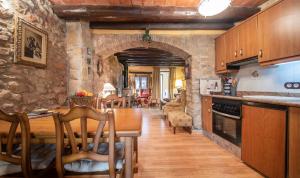 a kitchen and dining room with a table and chairs at Casa La morera del Montsant in La Morera de Montsant