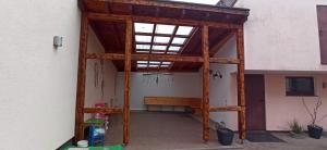 an open garage with a wooden structure at Ferienhaus Pauline in Sandberg