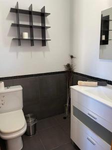 a bathroom with a white toilet and a sink at MiRA MAR in Lajita +10 photos