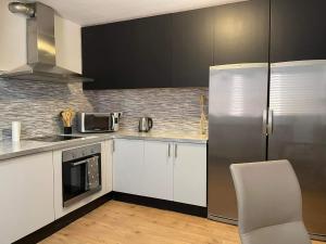 a kitchen with white cabinets and a refrigerator at MiRA MAR in Lajita