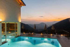 a swimming pool with a view of the mountains at Il Bagnolo Eco Lodge in Salò