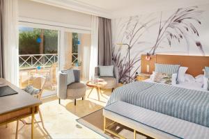a bedroom with a bed and a living room at Grupotel Parc Natural & Spa in Playa de Muro