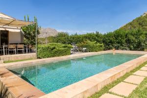 a swimming pool in the backyard of a house at Villa Cal Padri By SunVillas Mallorca in Pollença