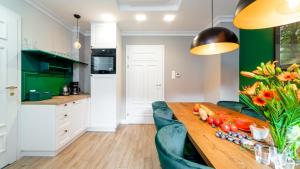 卡爾帕奇的住宿－ROYAL GREEN Apartamenty Deptak，厨房配有带蔬菜的木桌