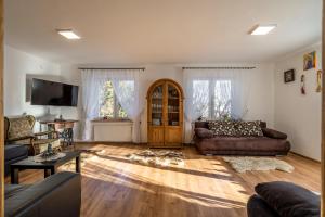 a living room with two couches and a tv at Chata Na Brzysku Pod Białką in Leśnica