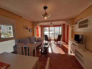 a living room with a couch and a table at Veracruz-Fincas Benidorm in Benidorm