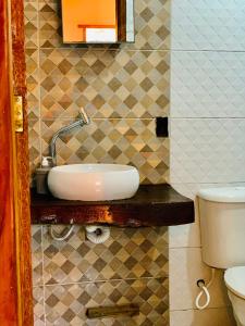 Un baño con lavabo e inodoro en Casa do sol, en Caraíva