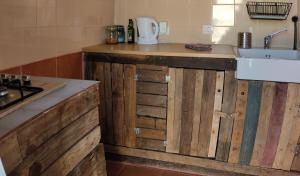 a kitchen with wooden cabinets and a sink at la casita de Máguez in Máguez