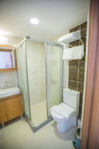 a bathroom with a shower and a toilet and a sink at Grand İstanbul Airport Hotel in Istanbul