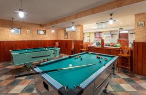 a billiard room with a pool table in it at Hotel Barátság in Hajdúszoboszló