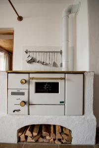 a kitchen with a stove and a fire place at Ferienwohnung Lacherhof in Seehausen am Staffelsee