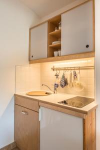 a kitchen with a sink and a counter at Ferienwohnung Lacherhof in Seehausen am Staffelsee