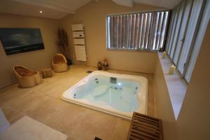 a bath tub in the middle of a room at La Haute Flourie - bed and breakfast -chambres d'hôtes in Saint Malo