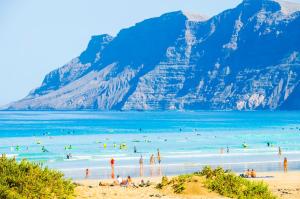 a group of people in the water at a beach at Seaview Famara 2 in Famara