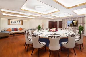 a conference room with a large table and chairs at Shenzhen Bay Hisoar Hotel in Shenzhen