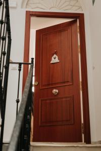 una puerta de madera con una campana encima en Casa da Catedral Jerónimo en Badajoz