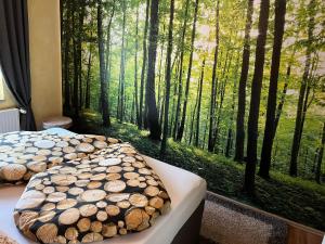 a bedroom with two beds and a large window with trees at Ferienwohnung Midgard in Thale