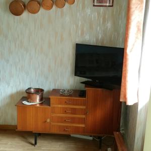 a television on top of a wooden dresser at Maison à Font-Romeu - Odeillo in Odeillo-Via