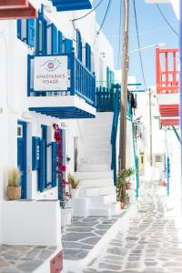 a street in positano with blue and white buildings at Anastasia's Visage Stylish Accommodation Rooms City Centre Mykonos in Mikonos