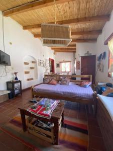 a bedroom with a bed and a table in a room at La Casa Chica in Maimará