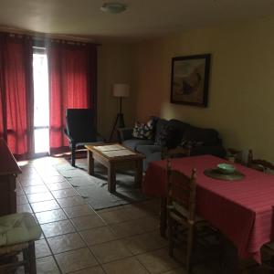 a living room with a couch and a table at apartamentos turisticos san juan de la peña in Santa Cruz de la Serós