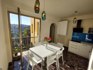 a white table and chairs in a kitchen with a balcony at Residenza Donini in Venice Suite 1 in Venice