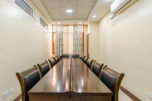 a conference room with a long table and chairs at Kibo Palace Apartments in Arusha