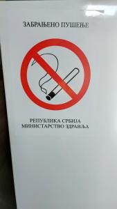 a sign with a no smoking sign on it at Apartman Santorini in Novi Sad