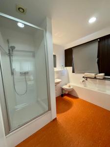 a bathroom with a shower and a toilet at Pension Messe in Feldkirchen