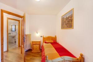 a small bedroom with a bed and a bathroom at A Due Passi Valdidentro in Isolaccia