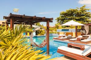 a pool at a resort with a slide at Aimberê Eco Resort Hotel in Coqueiro