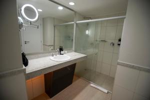 a bathroom with a sink and a shower at VIDAM Hotel Aracaju in Aracaju