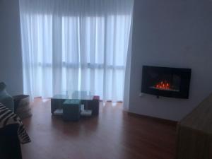 a living room with a fireplace in the wall at Granada-Cogollos Vega Village in Cogollos De La Vega