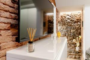 a bathroom with a white vanity with a mirror at Antico Basolato House in Catania