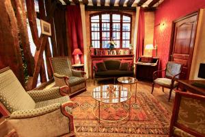 a living room with chairs and a table at Hotel de la Bretonnerie in Paris