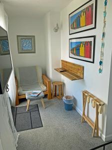 a living room with a couch and a chair at Porth Beach Hotel in Newquay