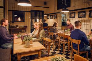 a group of people sitting at tables in a restaurant at Burgblickhotel in Bernkastel-Kues