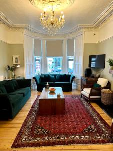 a living room with a couch and a coffee table at ByTheSea Guest House in Ayr