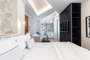 Säng eller sängar i ett rum på Le Dortoir Boutique Suites