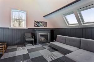 a living room with a couch and a fireplace at Landgoed Hermitage - Villa Euphoria - XXL Zwemspa - Max 10 personen in Ouddorp