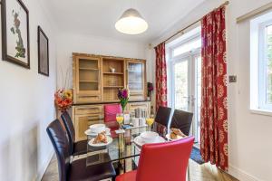 a dining room with a glass table and chairs at Bishy Road Hideaway near York Racecourse in York