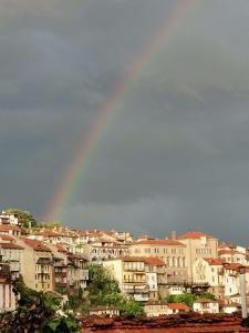 a rainbow in the sky over a city at Аврамов дом - етаж от къща in Veliko Tŭrnovo