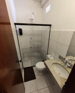 a bathroom with a shower and a toilet and a sink at Pousada Nossa Senhora D'Ajuda in Arraial d'Ajuda