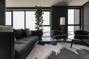 a living room with a couch and a table and chairs at InterContinental Malta by IHG in St Julian's +37 photos