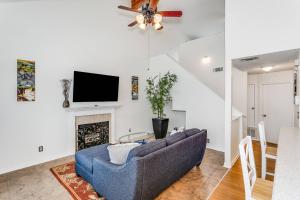 a living room with a blue couch and a fireplace at Sea Breeze Cottage in Gulf Breeze