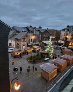 a group of people walking around a town with a christmas tree at Le perchoir de St-Antoine in Honfleur