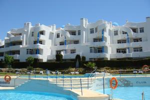 a large white apartment building with a swimming pool at Ona Campanario in La Cala de Mijas